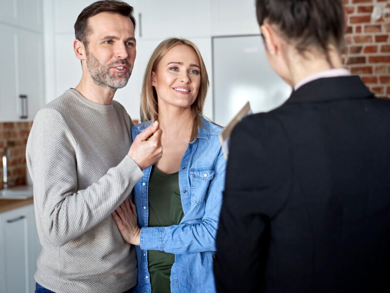 Couple talking to a real estate agent